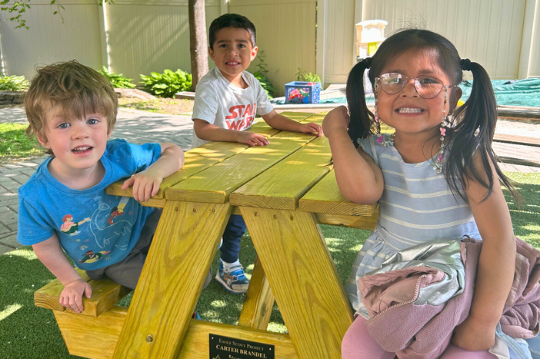 Teacher and children at The Children's Center